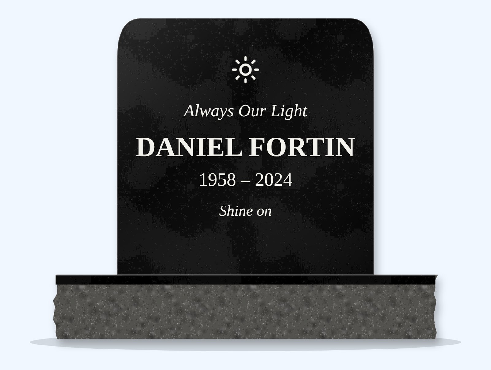 Absolute Black rounded top headstone on a granite base, engraved for Daniel Fortin