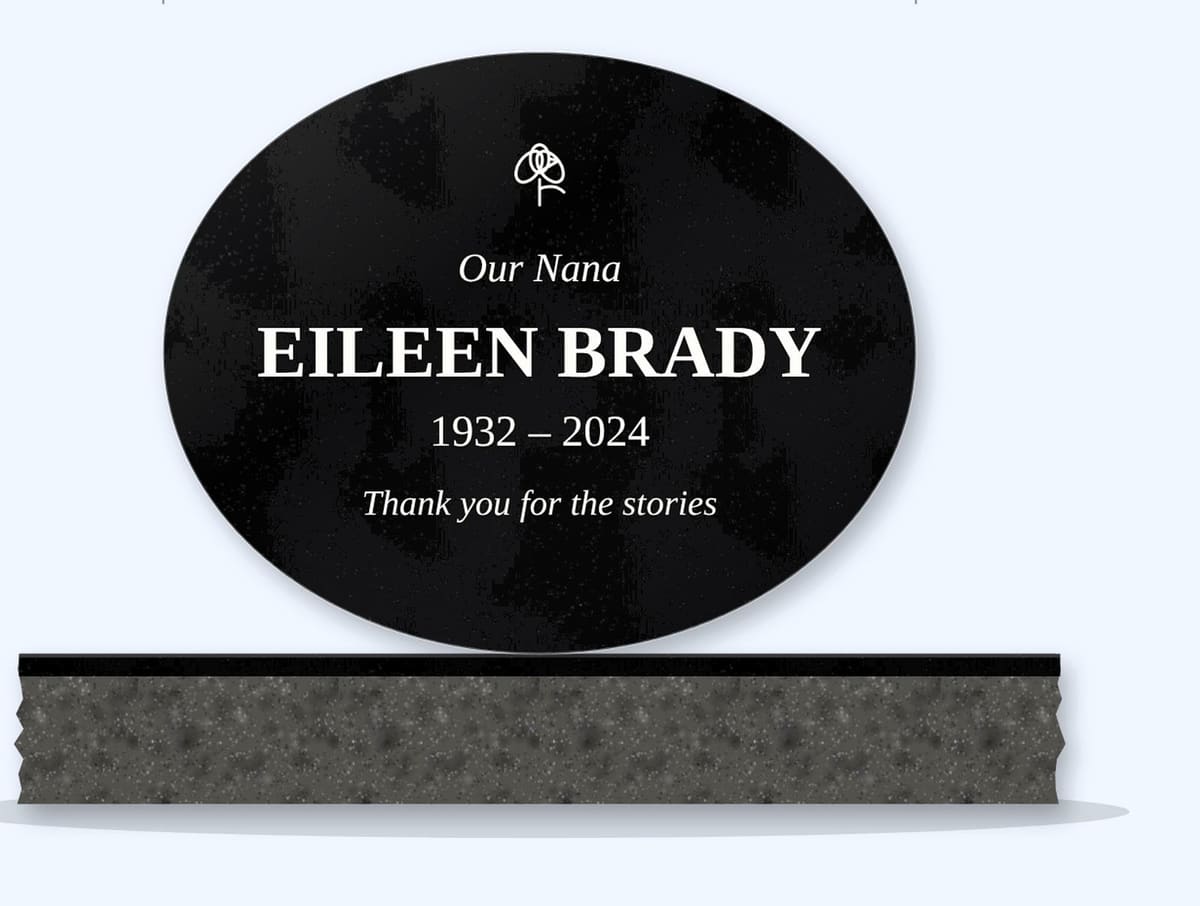 Absolute Black oval headstone on a granite base, engraved for Eileen Brady