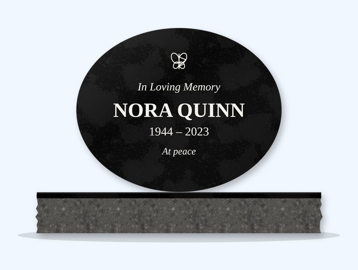 Absolute Black oval headstone on a granite base, engraved for Nora Quinn