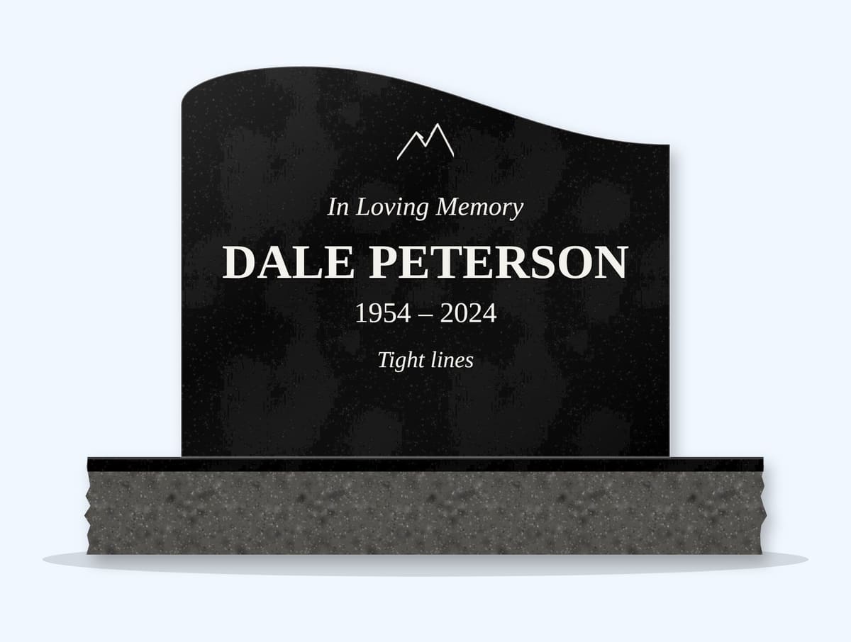 Absolute Black left wave headstone on a granite base, engraved for Dale Peterson