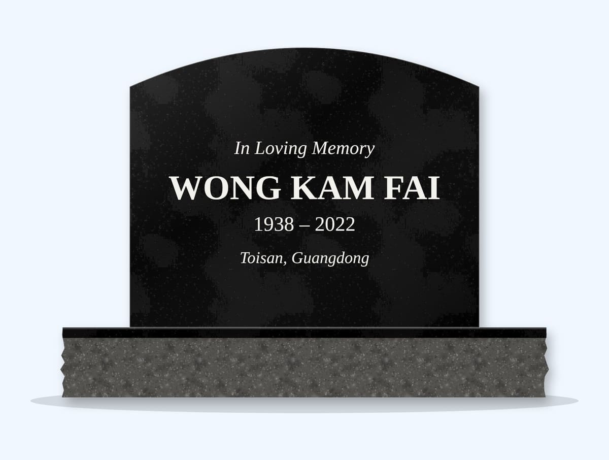 Absolute Black curved top headstone on a granite base, engraved for Wong Kam Fai
