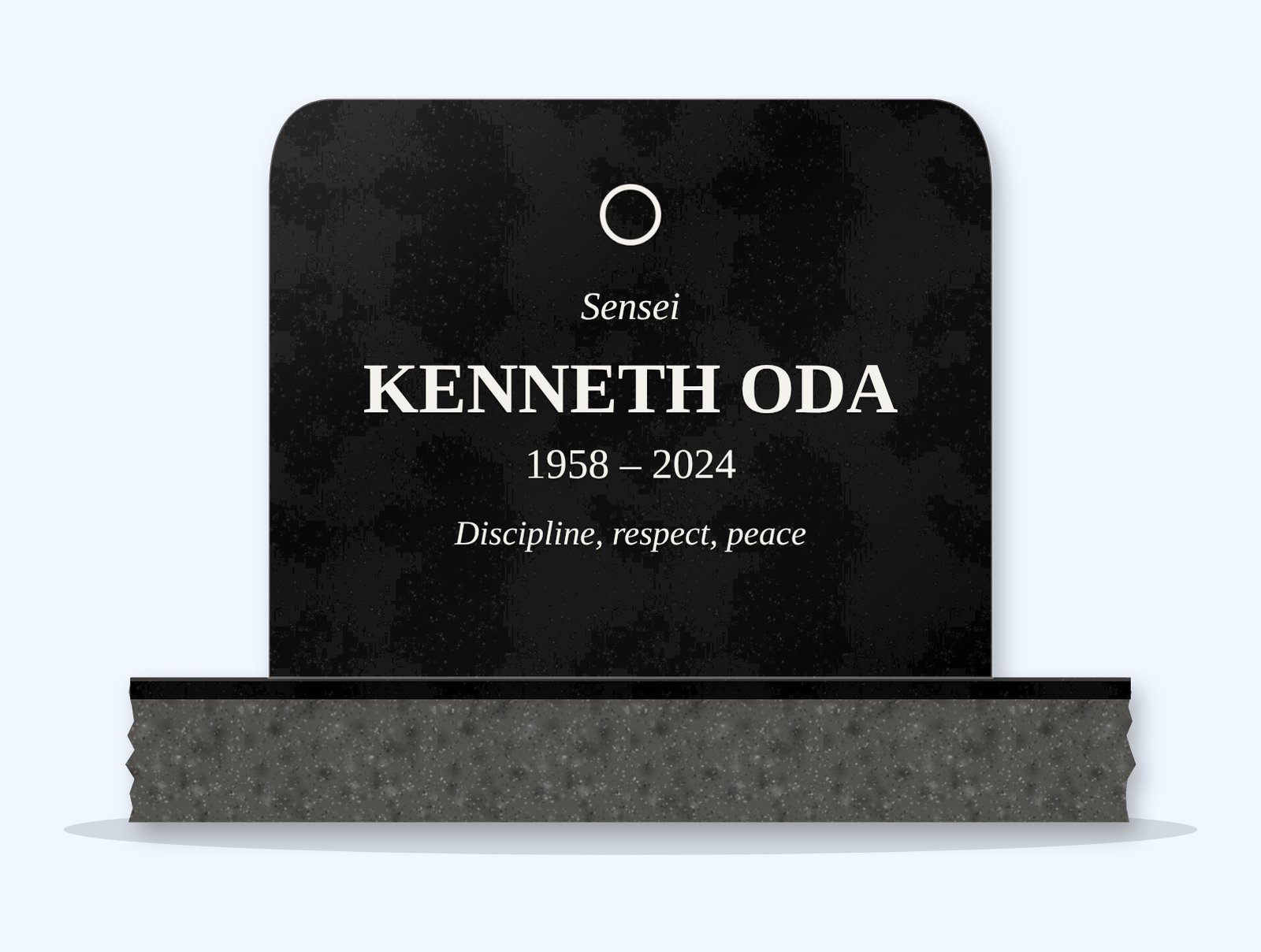 Absolute Black rounded top headstone on a granite base, engraved for Kenneth Oda