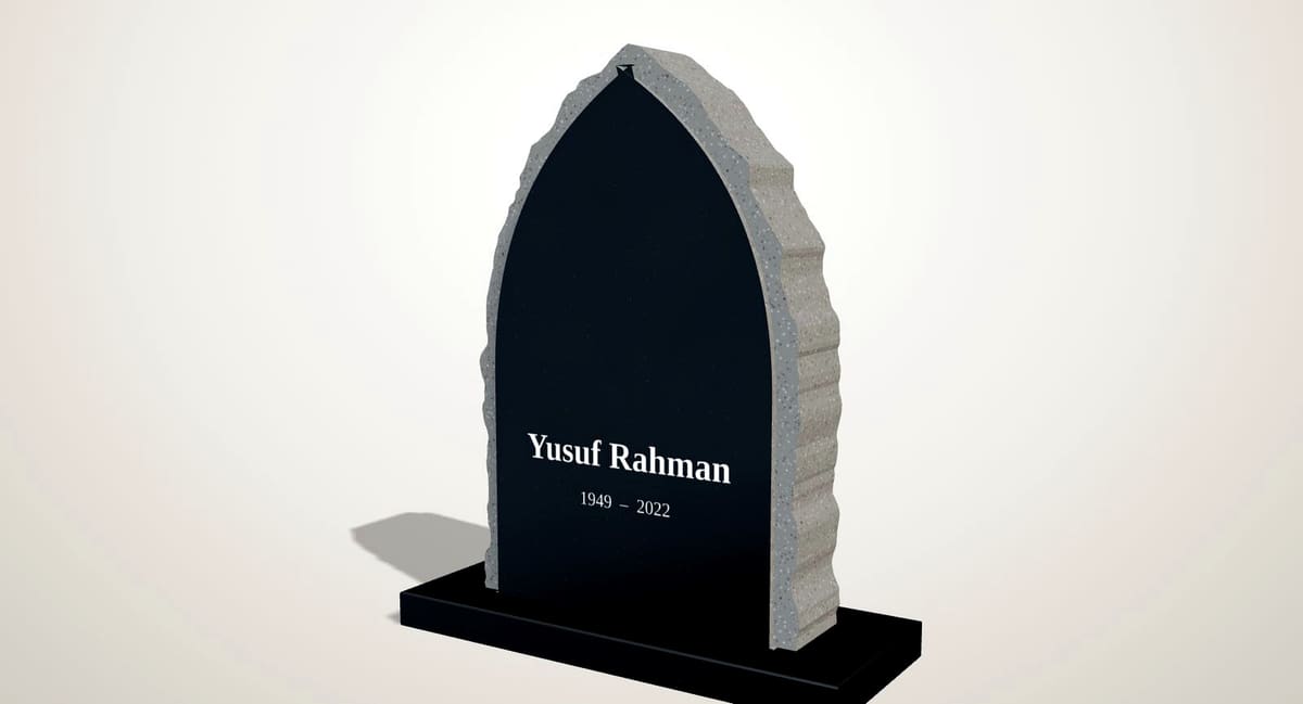 Simple black granite pointed-arch headstone with rock-pitched edges and a plain inscription