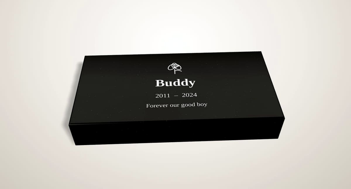 Small black granite flat memorial marker for a pet, engraved with a name and dates