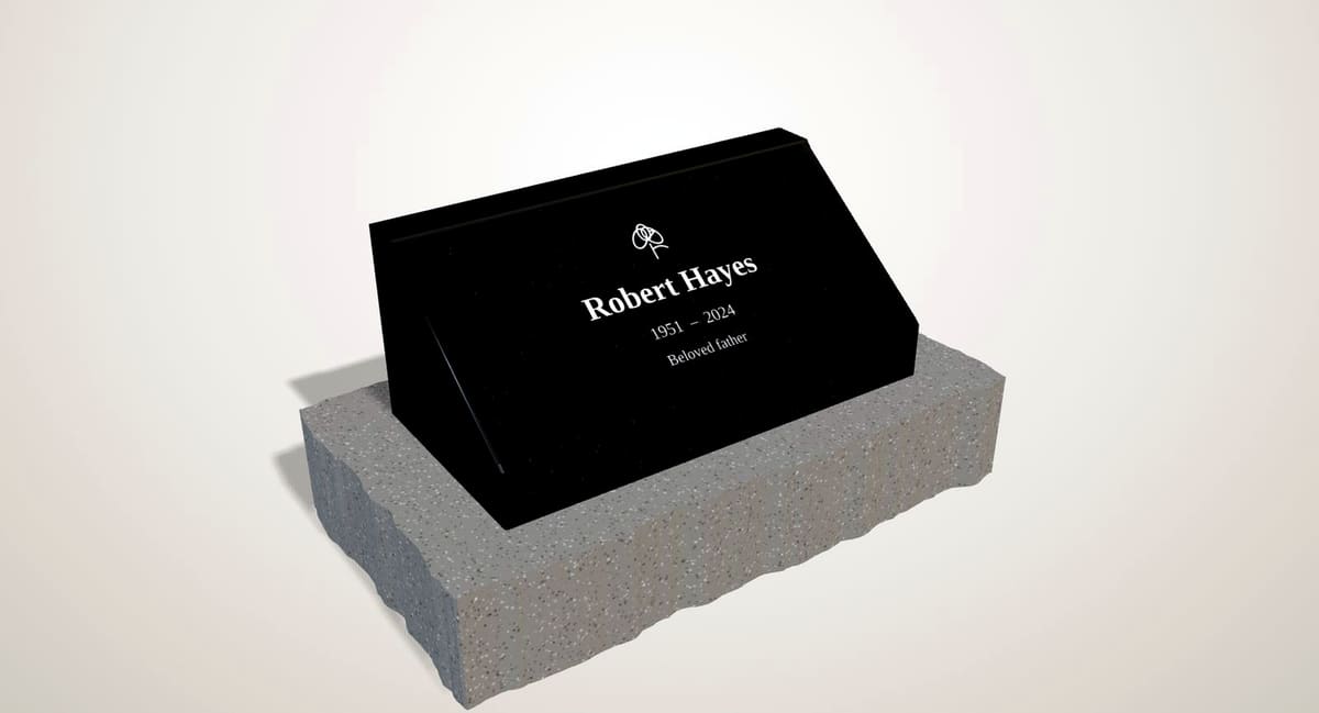 Black granite slant marker with a sloped engraved face on a rock-pitched grey base